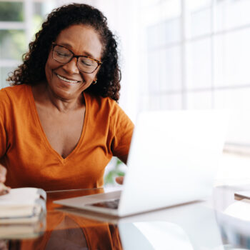 women on computer taking notes