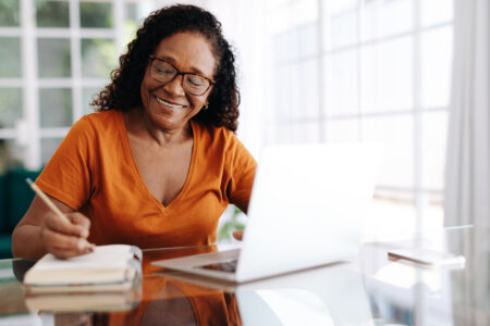 women on computer taking notes