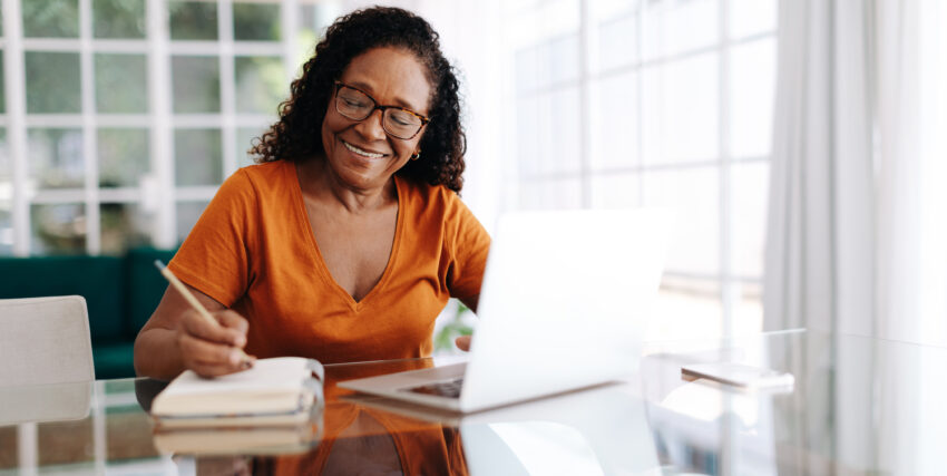 women on computer taking notes