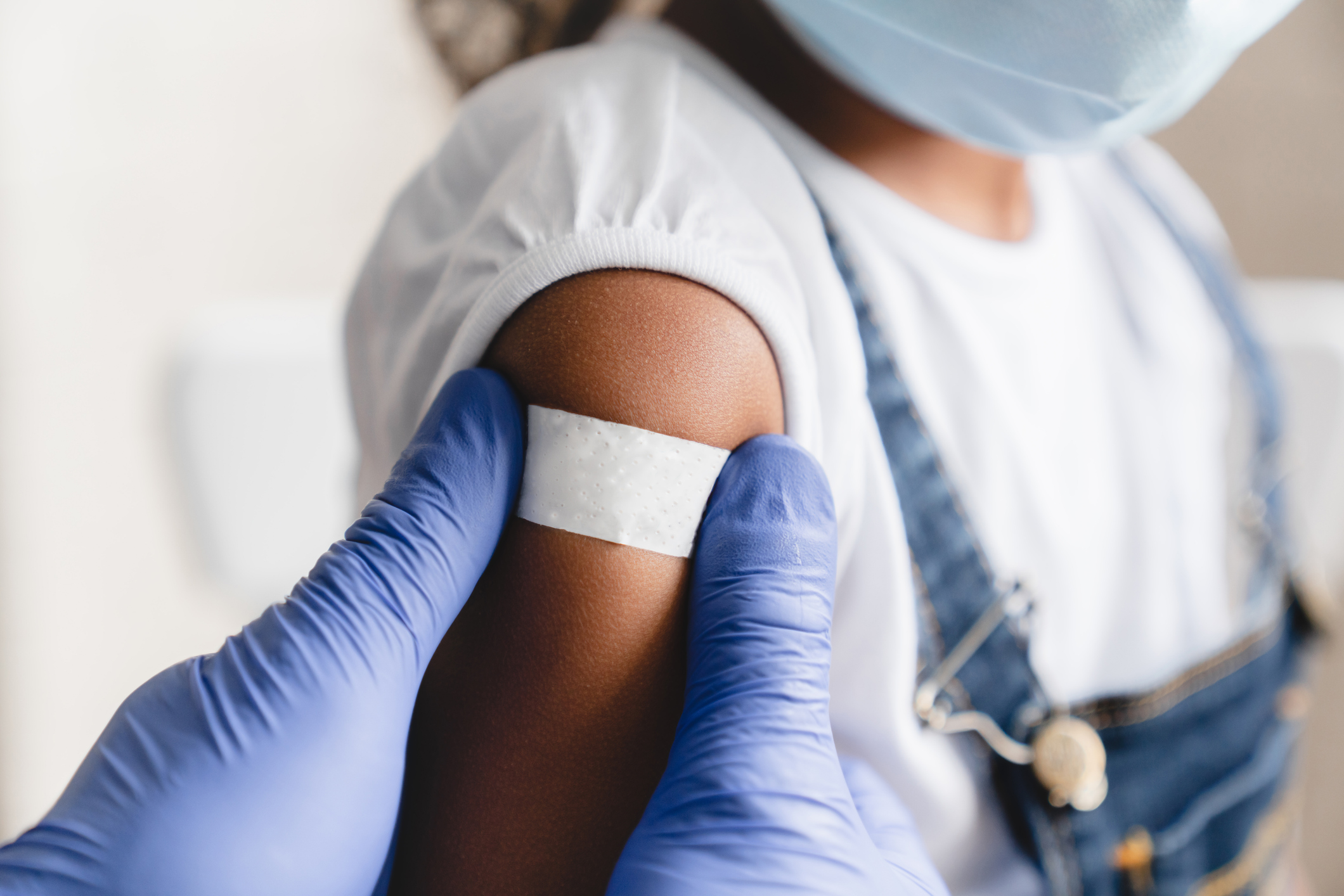 Nurse applying medical patch after injection