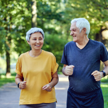 Senior couple jogging in the summer park