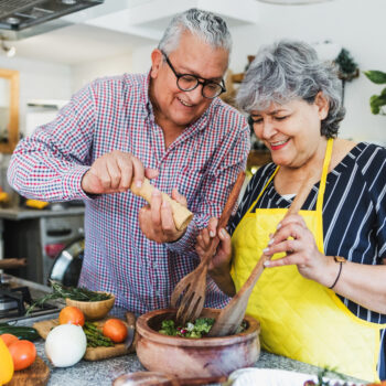 Couple cooking meal together.