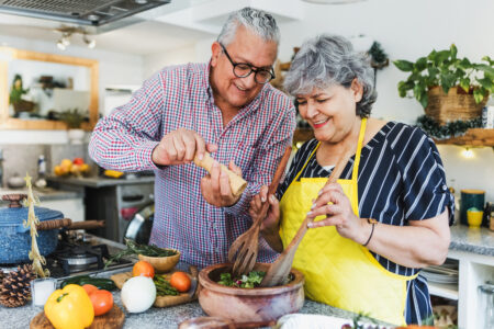 Couple cooking meal together.