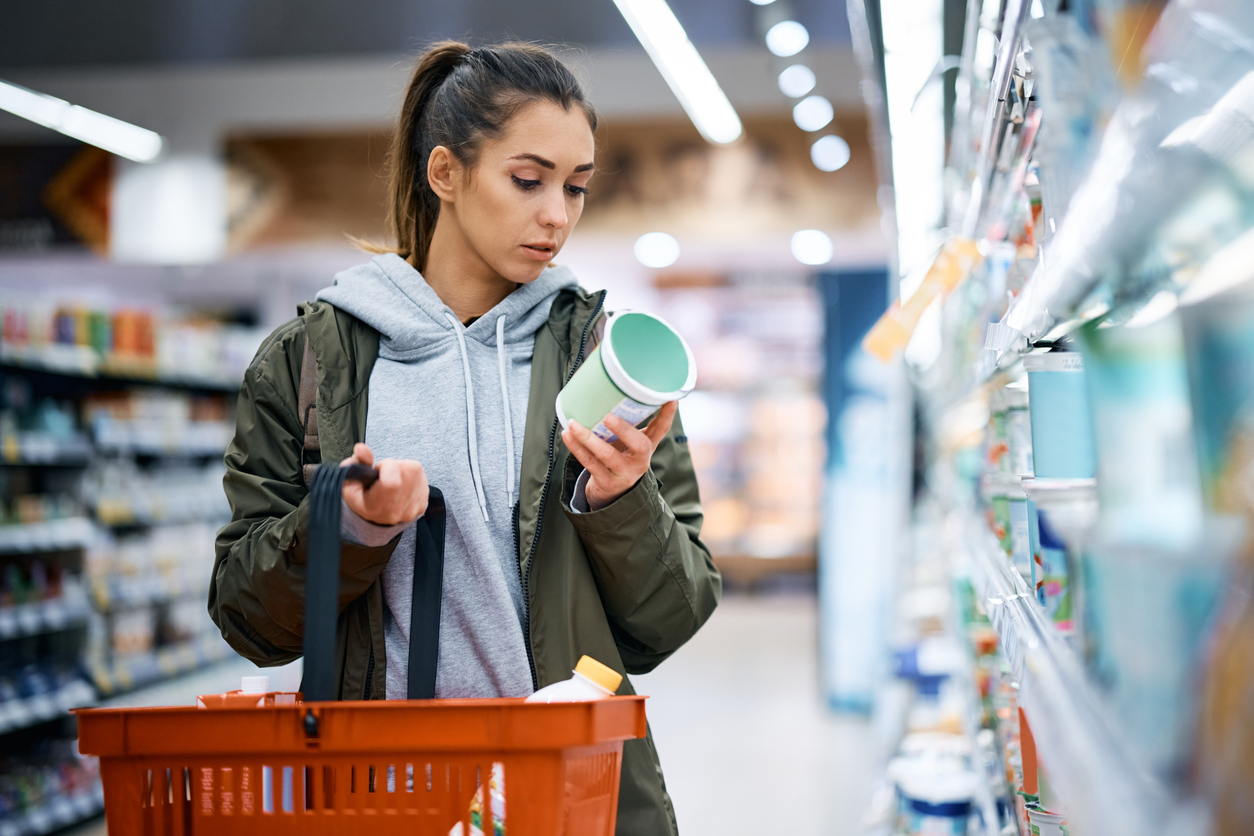 Women check nutrition label on food. 