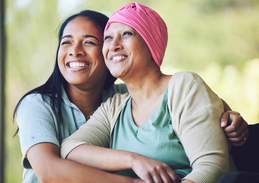 Happy, sweet and sick mature female person embracing her adult daughter with a smile in outdoor garden.