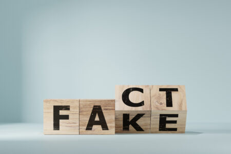 Flipping Wooden cube block for change fake to fact , news and social media concept.