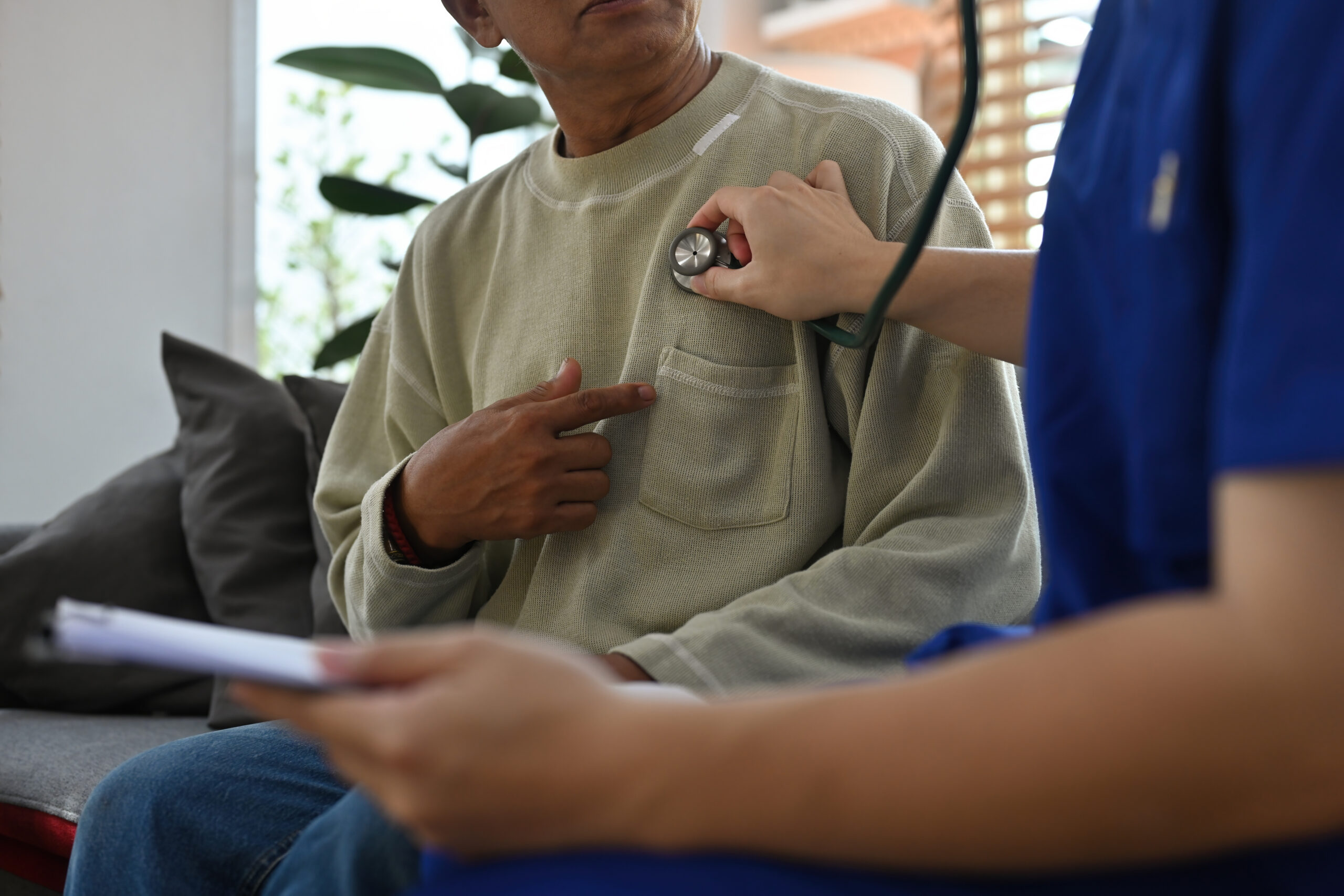Close up with Doctor using a stethoscope on old man patient, Health checks for the elderly at home, Nursing home, Detecting heart disease.