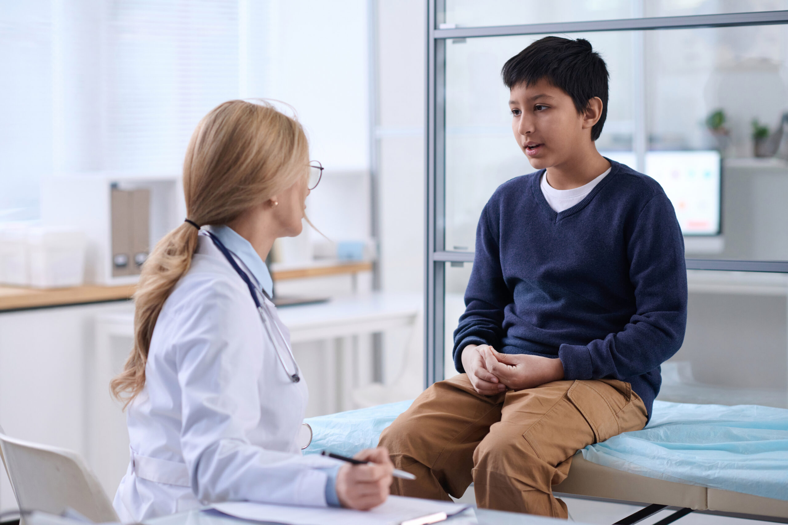 Boy Talking to Doctor in Clinic