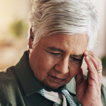 Retirement, thinking and old woman in house, sad and depression in living room, mental health and sofa. Contemplating, unhappy and mature person with anxiety, sickness and thoughts of senior care