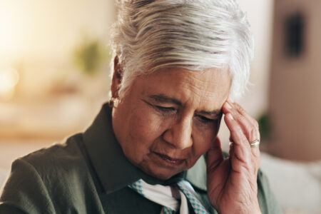 Retirement, thinking and old woman in house, sad and depression in living room, mental health and sofa. Contemplating, unhappy and mature person with anxiety, sickness and thoughts of senior care