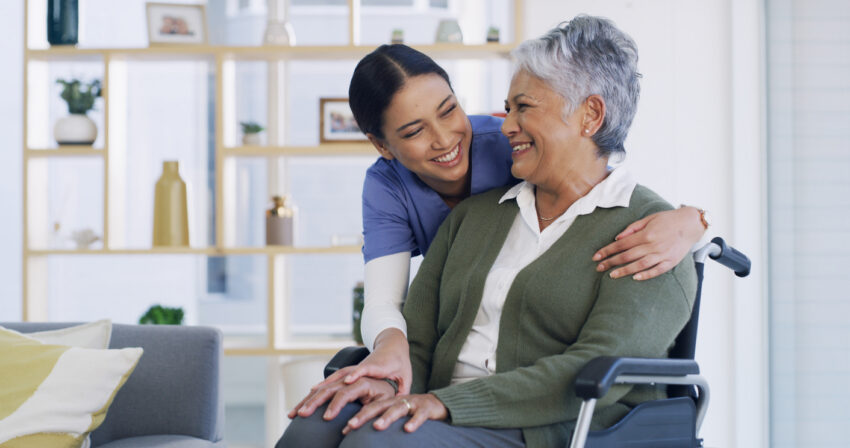 Happy, caregiver and old woman in wheelchair at house for assistance, medical advice and homecare. Smile, nurse and senior person with disability of support, healthcare trust and patient consultation