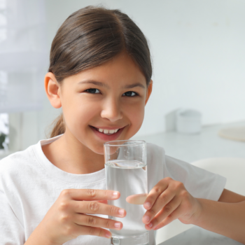 Girl holding a glass of water