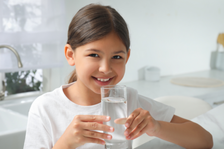 Girl holding a glass of water
