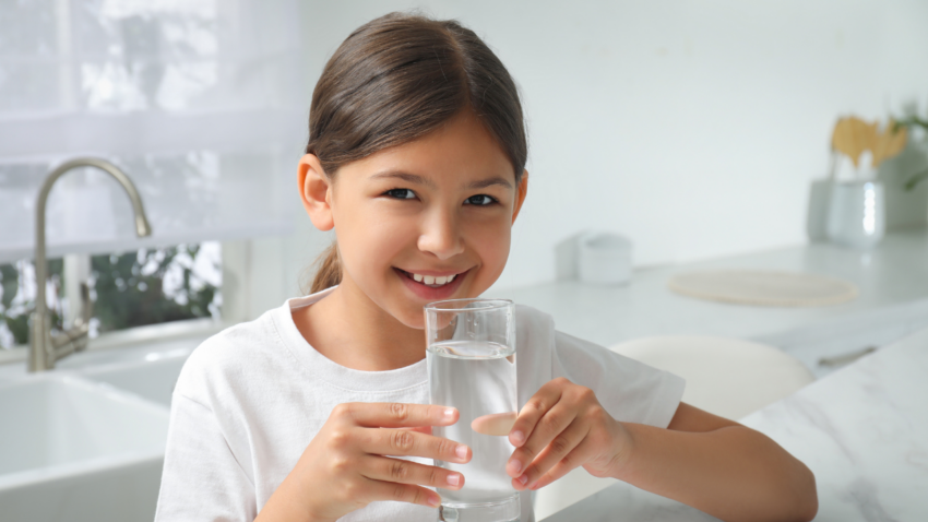Girl holding a glass of water