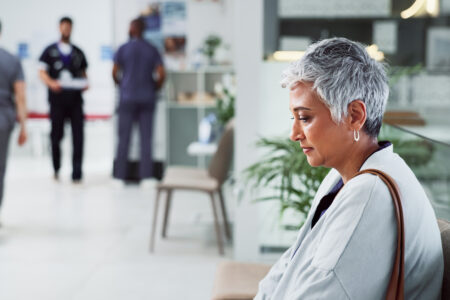 Thinking, sad and senior woman in clinic, grief and depression with emotions. Thoughts, mature person and old lady with results, medical and fear of cancer with loss, healthcare and hospital