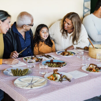 Latino family having dinner.