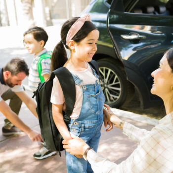 Parents helping children before school.