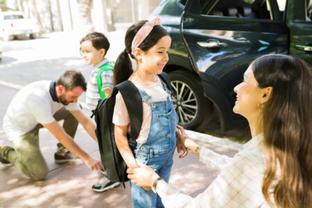 Parents helping children before school.