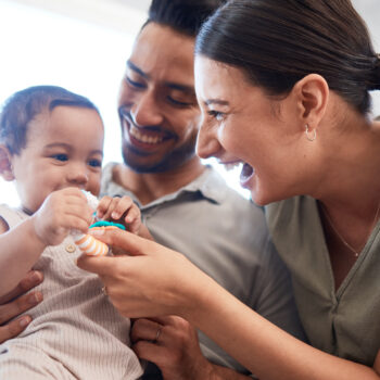 Shot of a young couple bonding with their baby girl on a sofa at home