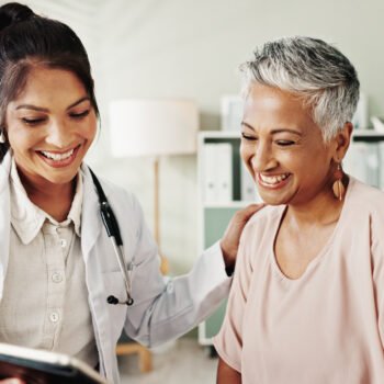Smile, doctor and senior patient on tablet in office for good news, research and online results of diagnosis. People, digital and healthcare report, insurance checklist and treatment plan and medical