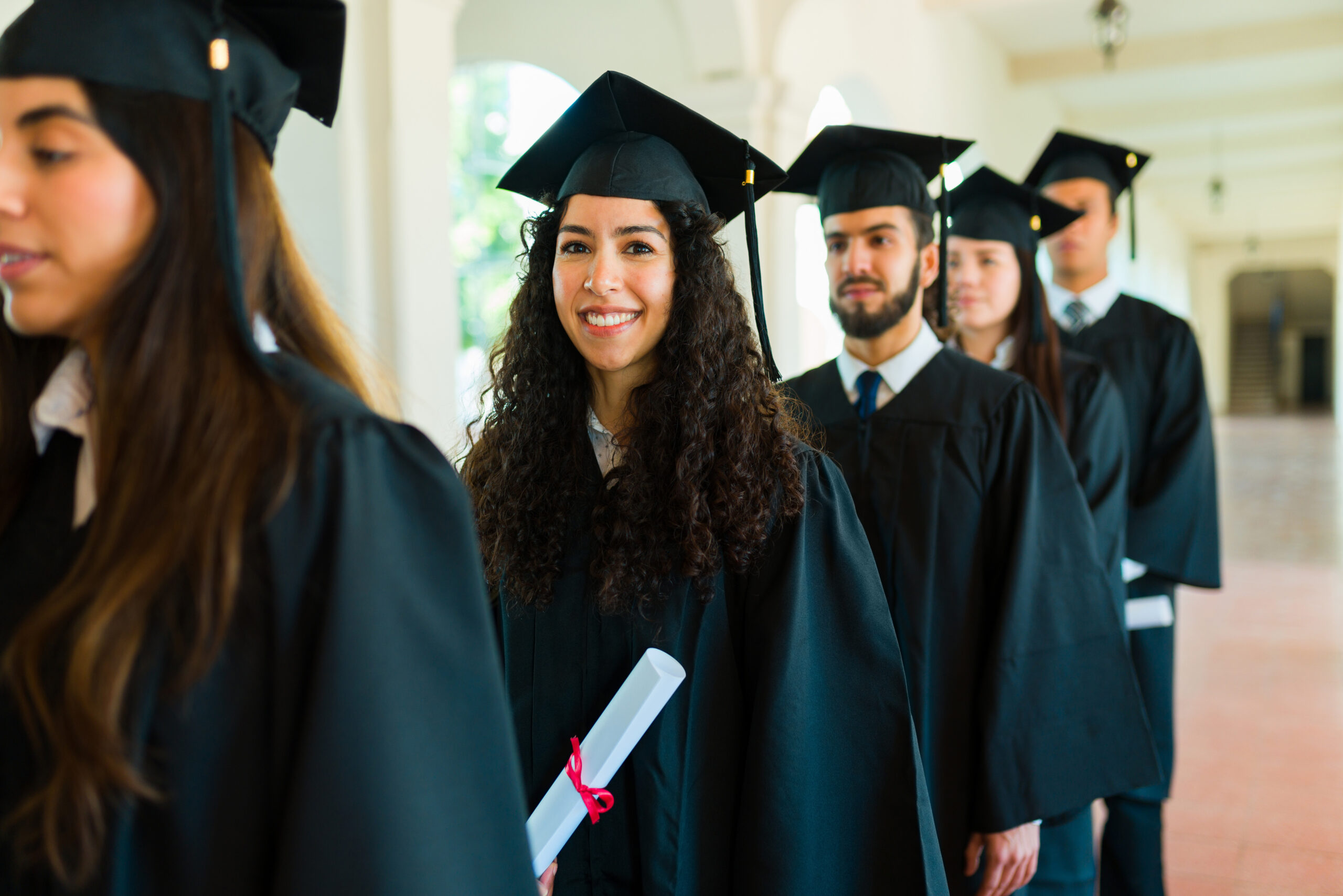 Cheerful latin woman happy about graduating university
